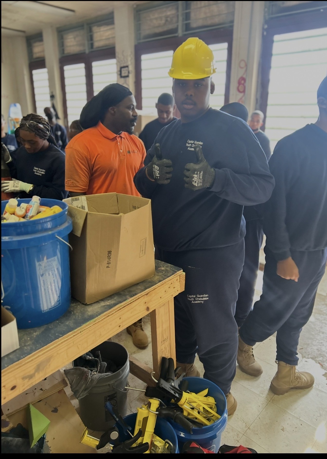 A trainee wearing a hardhat and gloves during safety training